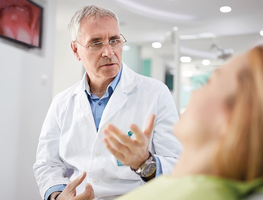 older male doctor explaining to female patient