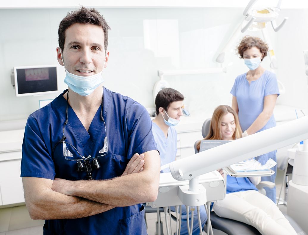 Male Doctor and Female Practitioner explaining chart to couple in dental/medical chair