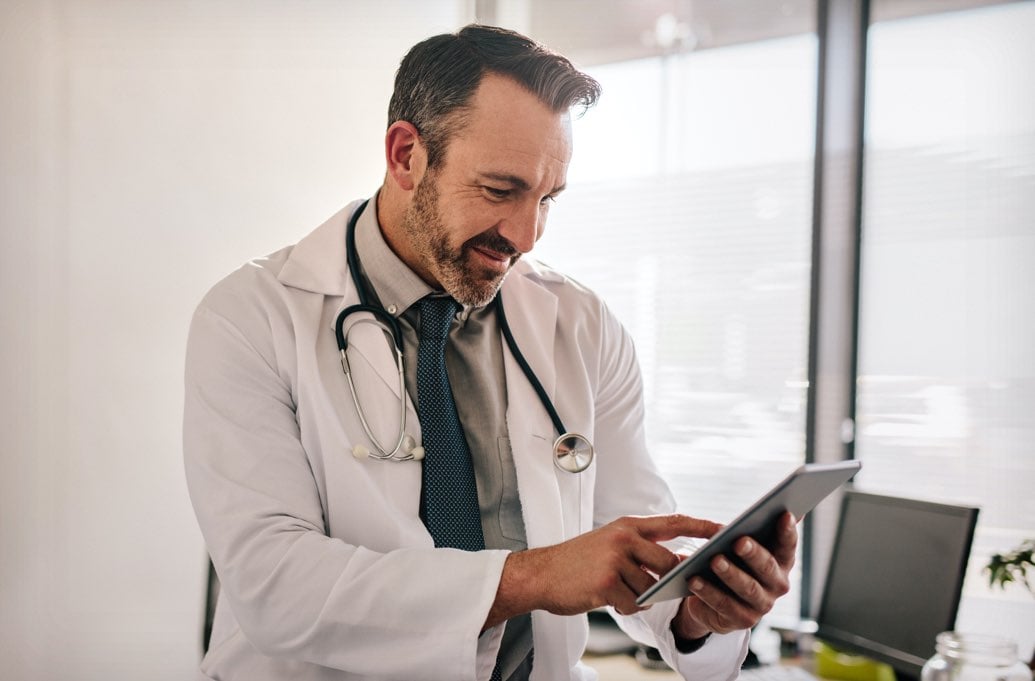 male doctor looking at tablet