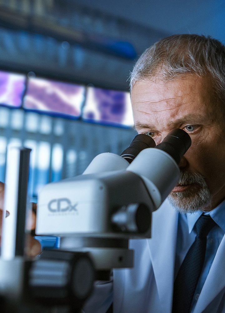 male doctor looking in microscope